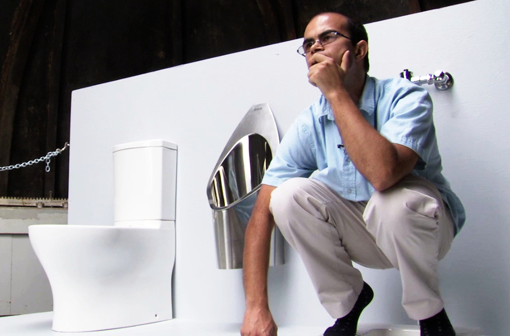 Graduate student Clement Cid sits atop the solar-powered toilet he helped to build at the California Institute of Technology in Pasadena, Calif. Underneath the platform, the toilet converts waste into fertilizer. The Caltech team will use fake feces to demonstrate the toilet's features next week at the Bill & Melinda Gates Foundation offices.