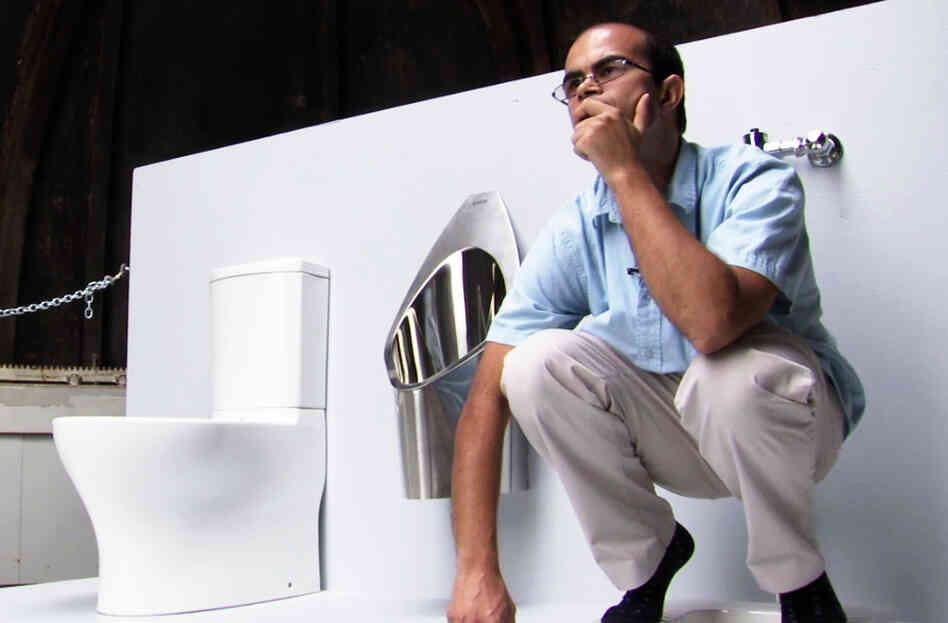 Graduate student Clement Cid sits atop the solar-powered toilet he helped to build at the California Institute of Technology in Pasadena, Calif. Underneath the platform, the toilet converts waste into fertilizer. The Caltech team will use fake feces to demonstrate the toilet's features next week at the Bill & Melinda Gates Foundation offices.