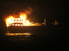 The burning dhow from which the U.S. Navy says it rescued 10 Iranians on Wednesday in the Gulf of Oman. The burning dhow from which the U.S. Navy says it rescued 10 Iranians on Wednesday in the Gulf of Oman.