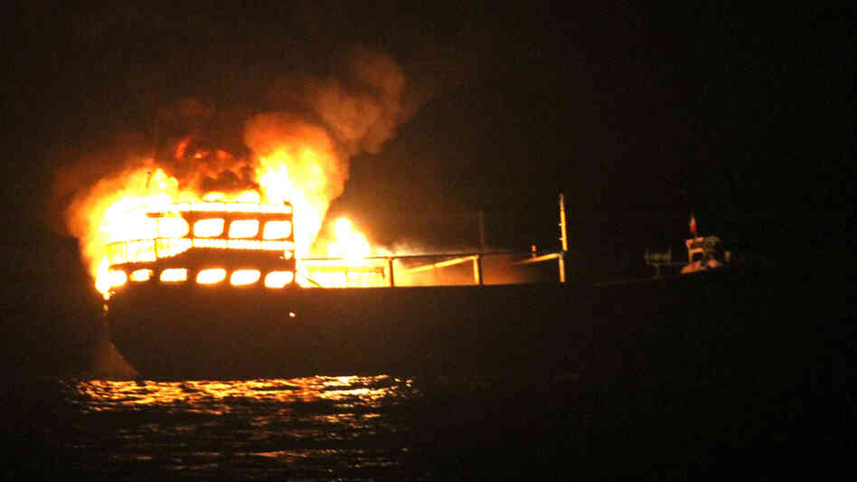 The burning dhow from which the U.S. Navy says it rescued 10 Iranians on Wednesday in the Gulf of Oman.