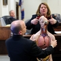 Dr. Amy Tharp, a forensic pathologist, explains gun shot wounds on an anatomical model during her testimony in Bedford, Va. in March 2010.