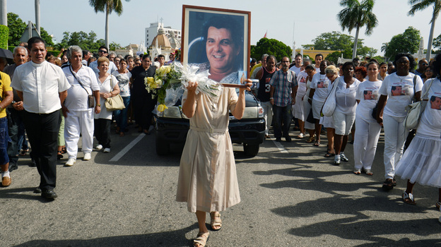 Oswaldo Paya, who challenged Cuba's communist regime for decades, died in a car crash on July 22. A Spanish man who was driving Paya has been charged with the equivalent of vehicular manslaughter. Here, a nun holds a portrait of Paya during his funeral in Havana. Oswaldo Paya, who challenged Cuba's communist regime for decades, died in a car crash on July 22. A Spanish man who was driving Paya has been charged with the equivalent of vehicular manslaughter. Here, a nun holds a portrait of Paya during his funeral in Havana.