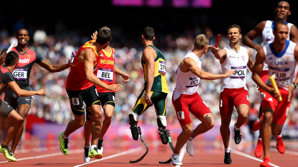 Anticipation: Oscar Pistorius of South Africa waits for the baton in the team 4x400m relay at London's Olympic Stadium. His teammate fell in the race, but officials deemed he had been interfered with. South Africa will run in the final.
