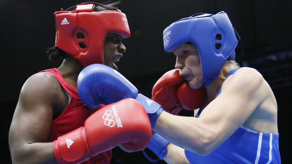U.S. boxer Claressa Shields (left) lands a punch on Nadezda Torlopova of Russia during the women's boxing middleweight final at the ExCel Arena in London. Shields, 17, won the first-ever gold medal in the event.