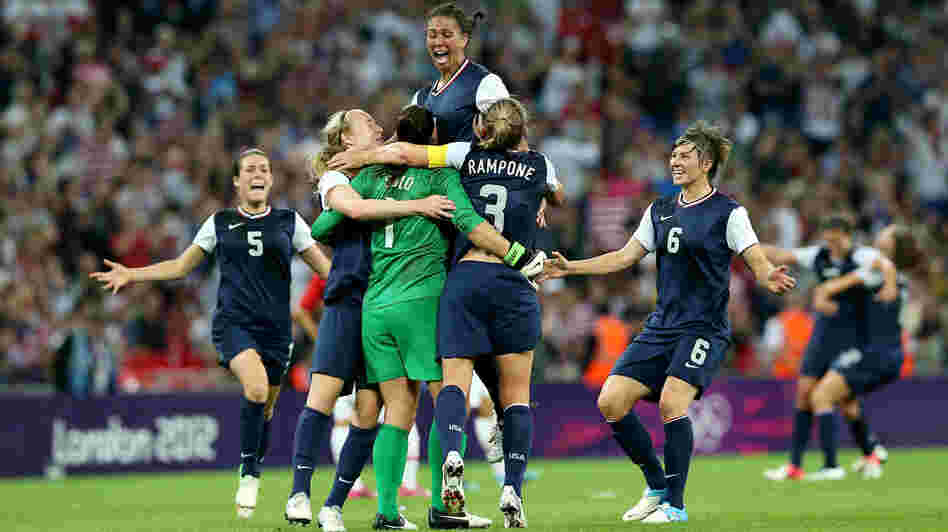 Hope Solo (in green), Shannon Boxx (top), Christie Rampone, Amy LePeilbet (right), and Kelley O'Hara (left) celebrate the U.S. women's soccer team's gold medal, after defeating Japan, 2-1, in London.