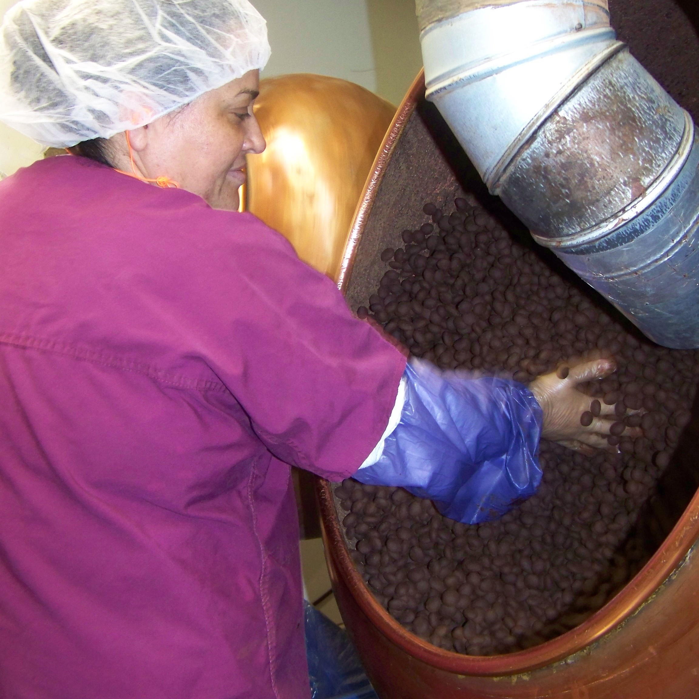 Lupe Lopez ensures a batch of Chukar's Cabernet Cherries are evenly coated with chocolate.