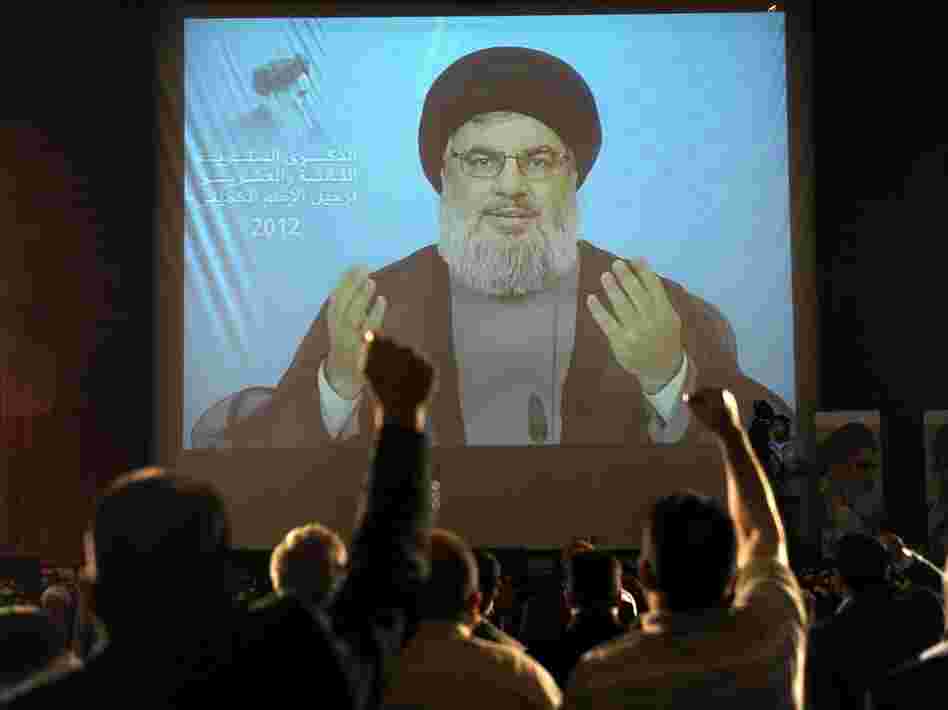 Hezbollah leader Sayyed Hassan Nasrallah, seen here delivering a speech via video in Beirut in June, has dismissed Assir's calls for disarmament.