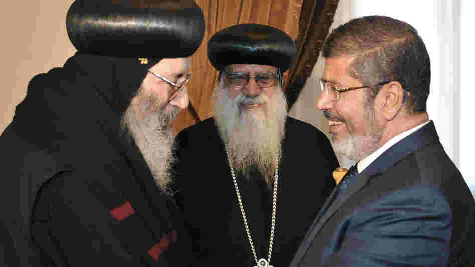 Then-President-elect Mohammed Morsi greets Coptic Bishop Bishoy (left) as Bishop Bakhomious looks on, at the presidential palace in Cairo in June, in this photo released by Egypt's official news agency. The election of Morsi, of the Muslim Brotherhood, has unnerved many Christians, who make up about 10 percent of Egypt's population. Then-President-elect Mohammed Morsi greets Coptic Bishop Bishoy (left) as Bishop Bakhomious looks on, at the presidential palace in Cairo in June, in this photo released by Egypt's official news agency. The election of Morsi, of the Muslim Brotherhood, has unnerved many Christians, who make up about 10 percent of Egypt's population.