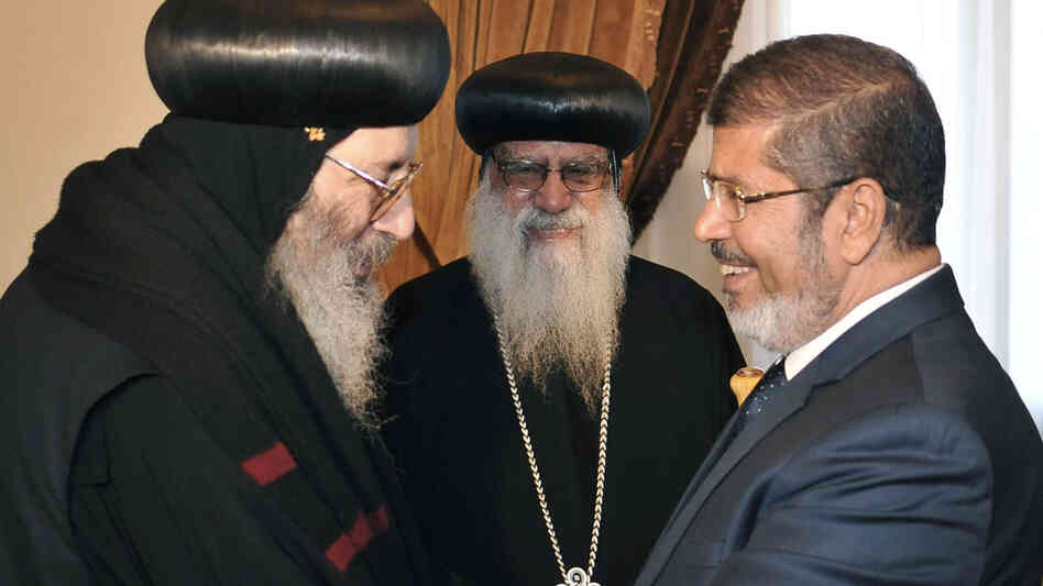 Then-President-elect Mohammed Morsi greets Coptic Bishop Bishoy (left) as Bishop Bakhomious looks on, at the presidential palace in Cairo in June, in this photo released by Egypt's official news agency. The election of Morsi, of the Muslim Brotherhood, has unnerved many Christians, who make up about 10 percent of Egypt's population. Then-President-elect Mohammed Morsi greets Coptic Bishop Bishoy (left) as Bishop Bakhomious looks on, at the presidential palace in Cairo in June, in this photo released by Egypt's official news agency. The election of Morsi, of the Muslim Brotherhood, has unnerved many Christians, who make up about 10 percent of Egypt's population.