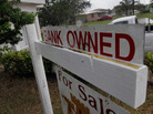 A "bank owned" sign in front of a home in Miami last October. A "bank owned" sign in front of a home in Miami last October.