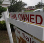 A "bank owned" sign in front of a home in Miami last October.