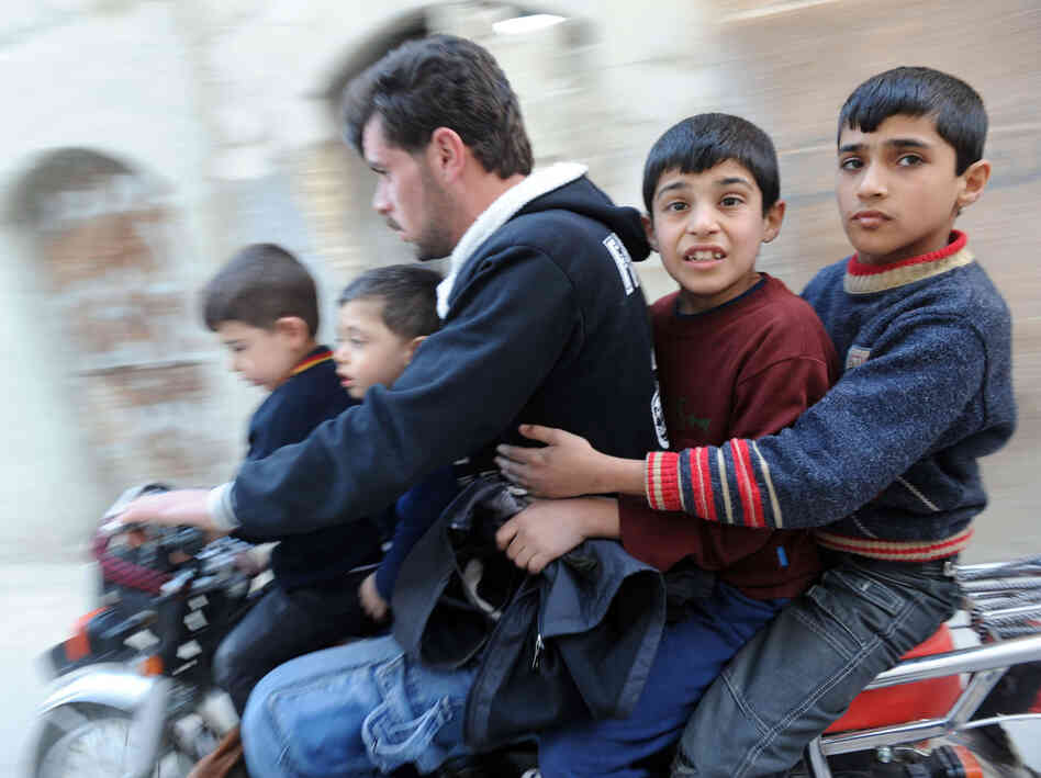In northwestern Syria earlier this year, this man and boys fled fighting.
