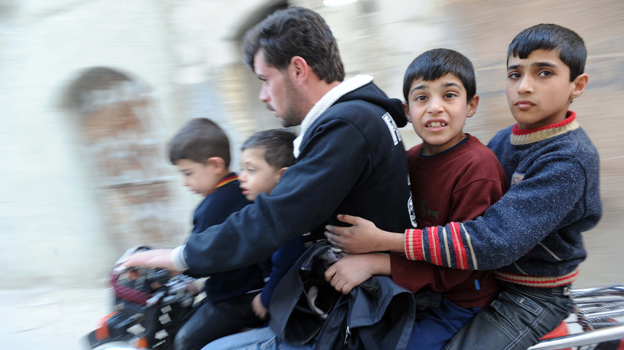 In northwestern Syria earlier this year, this man and boys fled fighting. (AFP/Getty Images)