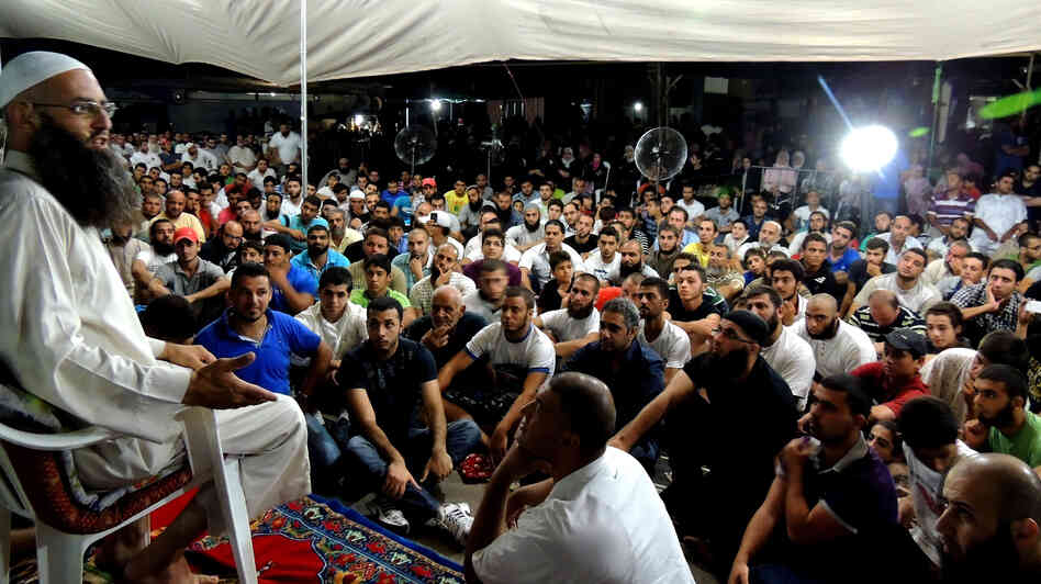 Sheik Ahmad Assir speaks to supporters at a tent encampment set up in protest against Hezbollah in Sidon, Lebanon. He accuses the Islamist militant group of using resistance against Israel as a smokescreen for another aim: advancing Iranian regional hegemony. Sheik Ahmad Assir speaks to supporters at a tent encampment set up in protest against Hezbollah in Sidon, Lebanon. He accuses the Islamist militant group of using resistance against Israel as a smokescreen for another aim: advancing Iranian regional hegemony.
