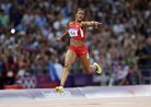 Carmelita Jeter of the U.S. points at the time board as she crosses the finish line to win the women's 4x100 meter relay at the Olympic Stadium on Day 14 of the London 2012 Olympic Games. The U.S. set a new world record by finishing the race in 40.82 seconds.