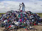 Mitchell Crow plays with his dog on what remains of 28,000 pounds of donated used clothes near Loneman, S.D. Unclaimed, the rain-soaked handouts began to go moldy during the summer. Mitchell Crow plays with his dog on what remains of 28,000 pounds of donated used clothes near Loneman, S.D. Unclaimed, the rain-soaked handouts began to go moldy during the summer.