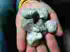 This photo photo from the New Zealand Defense Force shows a handful of the rocks found floating in the South Pacific.