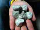 This photo photo from the New Zealand Defense Force shows a handful of the rocks found floating in the South Pacific.