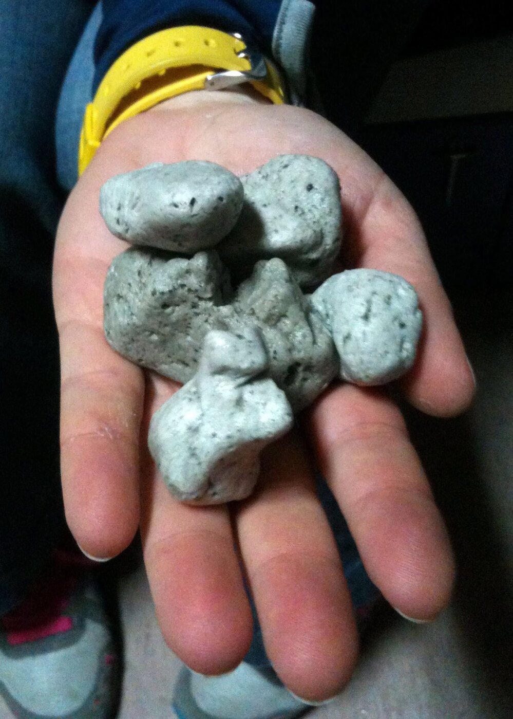 This photo photo from the New Zealand Defense Force shows a handful of the rocks found floating in the South Pacific.
