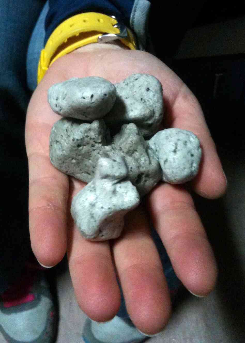 This photo photo from the New Zealand Defense Force shows a handful of the rocks found floating in the South Pacific.