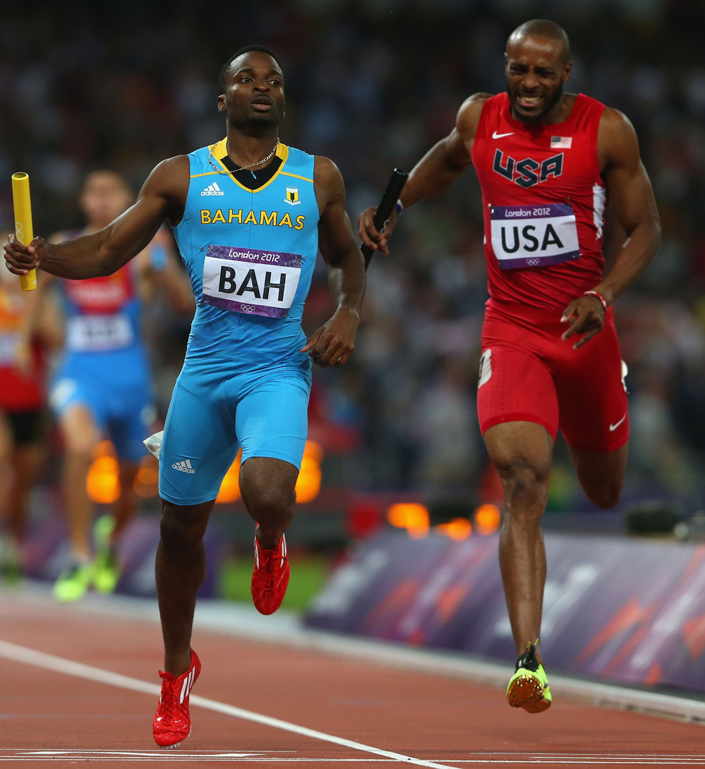 Ramon Miller (left) of the Bahamas crosses the finish line ahead of Team USA's Angelo Taylor to win the 4x400m relay gold medal at the London 2012 Olympics.