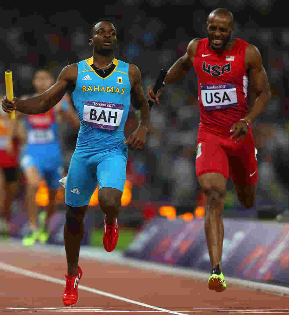 Ramon Miller (left) of the Bahamas crosses the finish line ahead of Team USA's Angelo Taylor to win the 4x400m relay gold medal at the London 2012 Olympics.