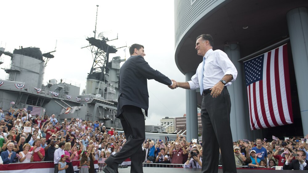 Rep. Paul Ryan of Wisconsin shakes hands with Mitt Romney as he's introduced as Romney's vice presidential running mate Saturday in Norfolk, Va. The USS Wisconsin is in the background.