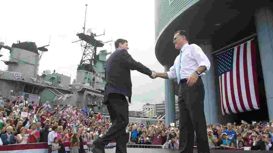 Rep. Paul Ryan of Wisconsin shakes hands with Mitt Romney as he's introduced as Romney's vice presidential running mate Saturday in Norfolk, Va. The USS Wisconsin is in the background.