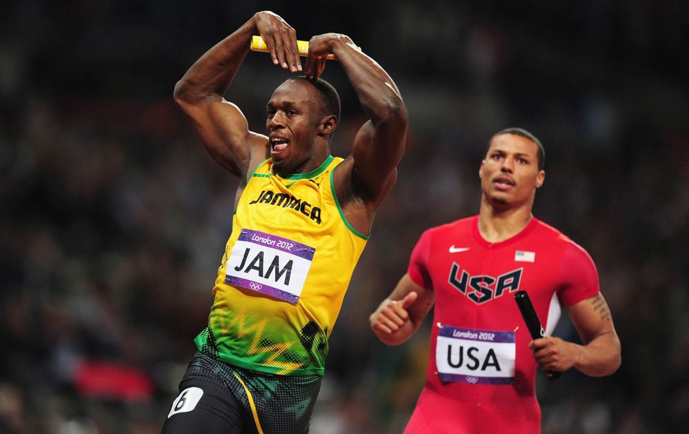 Usain Bolt of Jamaica celebrates his relay team's world record by doing the "mobot" move, made famous by Mo Farah of Britain. Bolt crossed the finish line in front of Ryan Bailey of the United States.