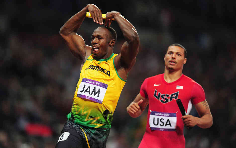 Usain Bolt of Jamaica celebrates his relay team's world record by doing the "mobot" move, made famous by Mo Farah of Britain. Bolt crossed the finish line in front of Ryan Bailey of the United States.
