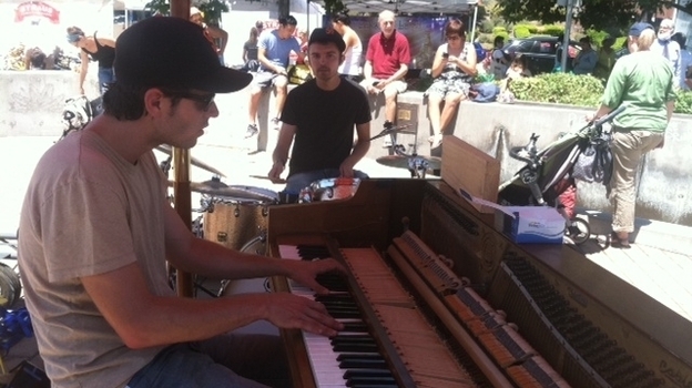 Pianist Kirby Lee Hammel and drummer Jake Alexander perform as Clangin' & Bangin' at an Oakland farmers market.