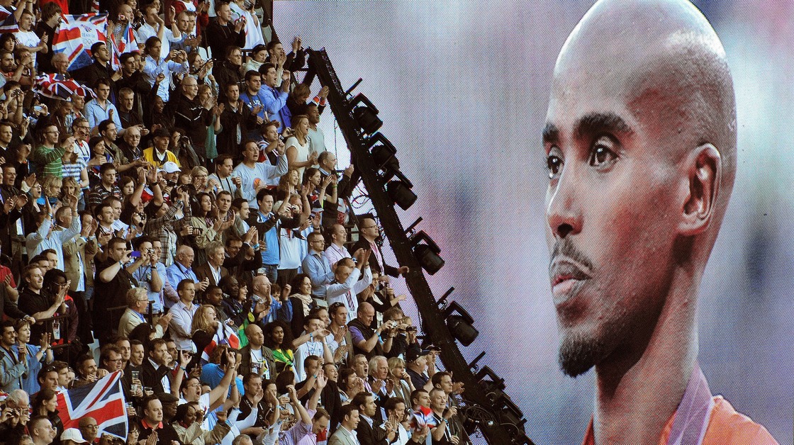 British runner Mo Farah is cheered as he appears on a giant screen at Olympic Stadium, accepting his gold medal for the 10,000 meters. Farah has become a celebrity in Britain since his win.