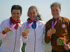 France's gold medalist Julie Bresset (center), Germany's silver medalist Sabine Spitz (left) and U.S. bronze medalist Georgia Gould stand on the podium of the women's cycling cross-country mountain bike event in Benfleet, England. France's gold medalist Julie Bresset (center), Germany's silver medalist Sabine Spitz (left) and U.S. bronze medalist Georgia Gould stand on the podium of the women's cycling cross-country mountain bike event in Benfleet, England.