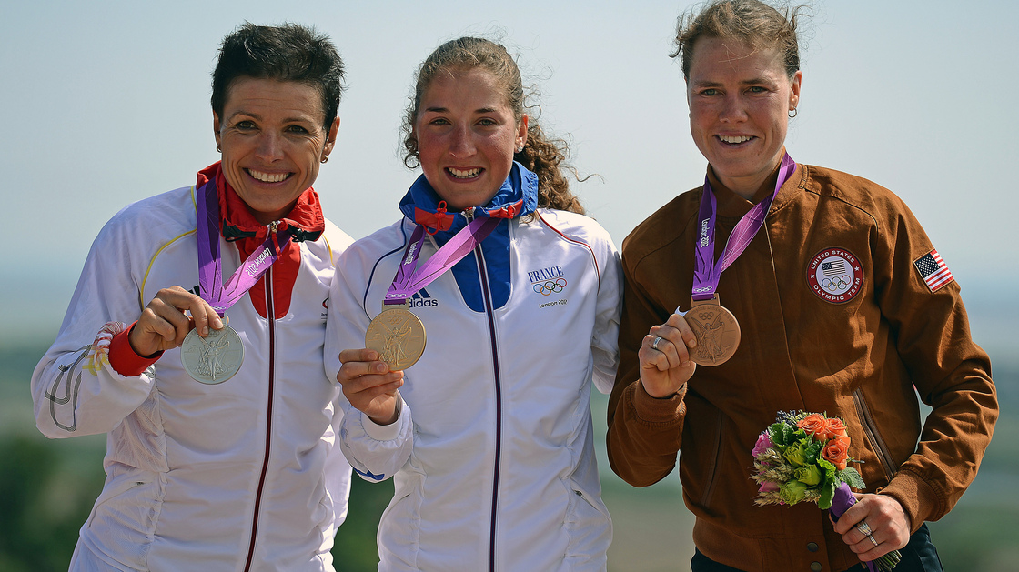 France's gold medalist Julie Bresset (center), Germany's silver medalist Sabine Spitz (left) and U.S. bronze medalist Georgia Gould stand on the podium of the women's cycling cross-country mountain bike event in Benfleet, England.
