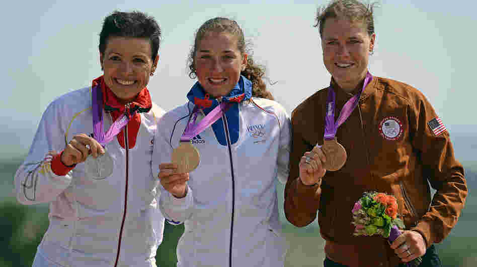 France's gold medalist Julie Bresset (center), Germany's silver medalist Sabine Spitz (left) and U.S. bronze medalist Georgia Gould stand on the podium of the women's cycling cross-country mountain bike event in Benfleet, England.