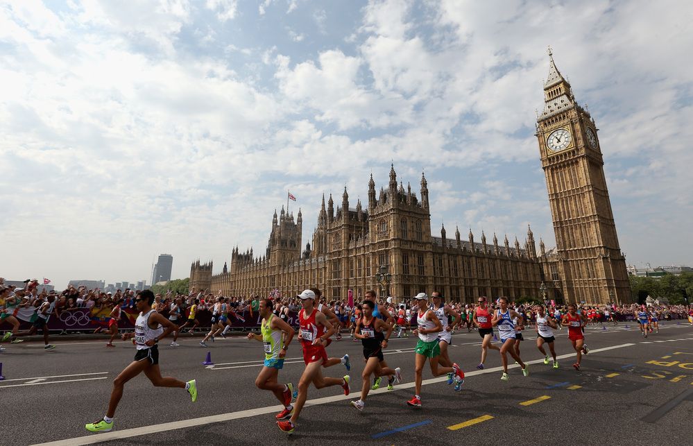 Athletes run along Westminster Bridge next to the Palace of Westminster as they compete in the Men's Marathon in London.