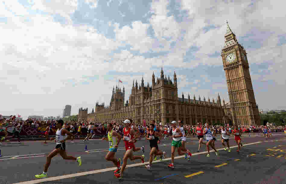 Athletes run along Westminster Bridge next to the Palace of Westminster as they compete in the Men's Marathon in London.