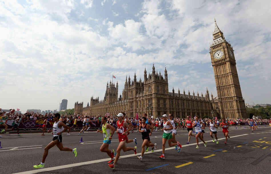 Athletes run along Westminster Bridge next to the Palace of Westminster as they compete in the Men's Marathon in London.