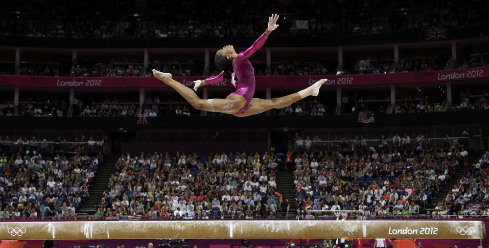 In an iconic moment, Gabrielle Douglas performs on the balance beam during the artistic gymnastics women's individual all-around competition at the 2012 Summer Olympics in London.
