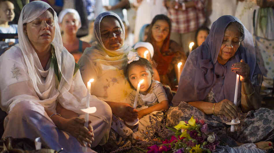 People attend a candlelight vigil for the victims of the Aug. 5 shooting at the Sikh Temple of Wisconsin in Oak Creek, Wis., on Aug. 7.