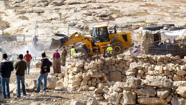 Israeli army tractors demolish a Palestinian home on Nov. 24, 2011, in the village of Yatta near Hebron, reported to be in Area C, an Israeli-controlled section of the West Bank. Recently, Israel has issued orders to evacuate and demolish more Palestinian communities in Area C, the largest section of the West Bank.