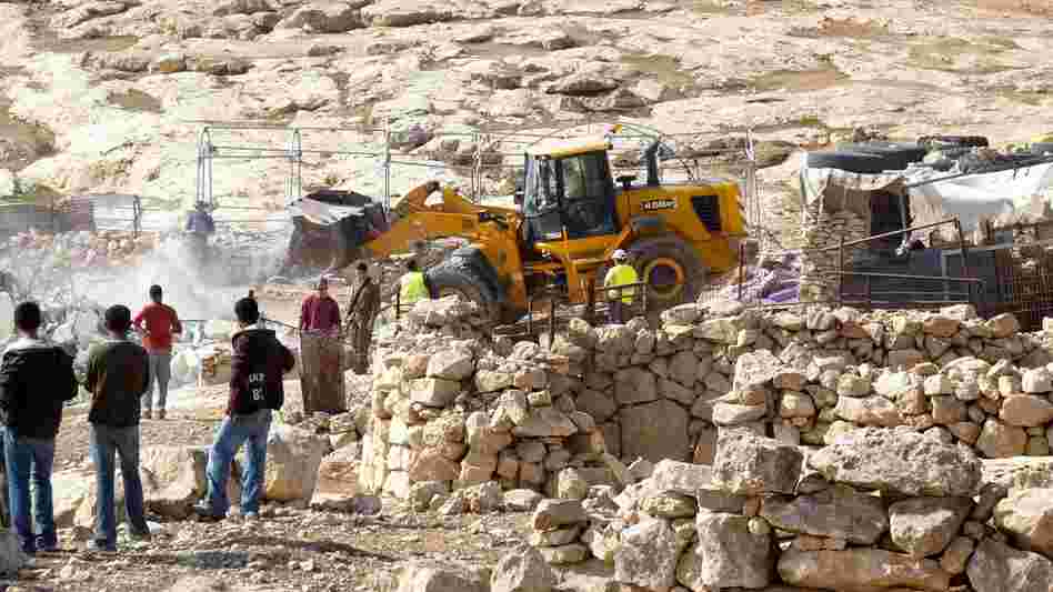 Israeli army tractors demolish a Palestinian home on Nov. 24, 2011, in the village of Yatta near Hebron, reported to be in Area C, an Israeli-controlled section of the West Bank. Recently, Israel has issued orders to evacuate and demolish more Palestinian communities in Area C, the largest section of the West Bank.