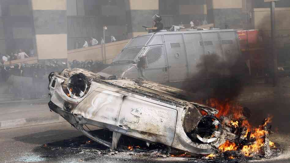 A car burns after riots break out in front of a luxury hotel in central Cairo on Aug. 2. Cairo and other parts of Egypt have seen an increase in crime and lawlessness since the country's revolution last year. A car burns after riots break out in front of a luxury hotel in central Cairo on Aug. 2. Cairo and other parts of Egypt have seen an increase in crime and lawlessness since the country's revolution last year.
