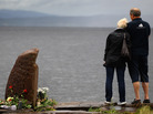 July 24, 2011: A man and woman look out across Tyrifjorden Lake towards Utoya Island, where 69 of the victims were killed. July 24, 2011: A man and woman look out across Tyrifjorden Lake towards Utoya Island, where 69 of the victims were killed.