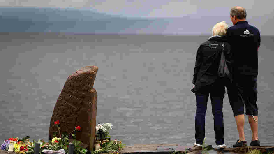July 24, 2011: A man and woman look out across Tyrifjorden Lake towards Utoya Island, where 69 of the victims were killed.