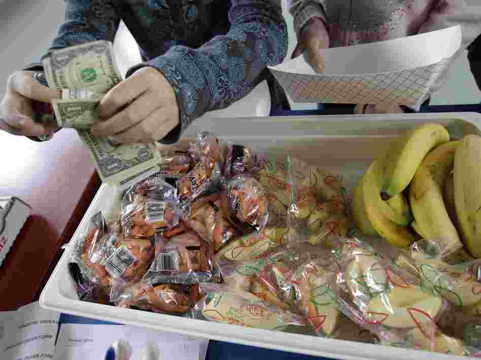 A student at Fairmeadow Elementary School buys fruits and vegetables in Palo Alto, Calif., in 2010.