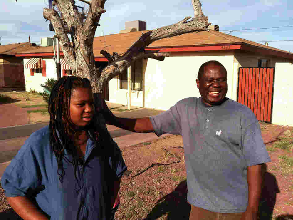 John Larsala struggles to keep his family cool during the Phoenix summer. The shade trees in his front yard have died because he cannot afford to water them.