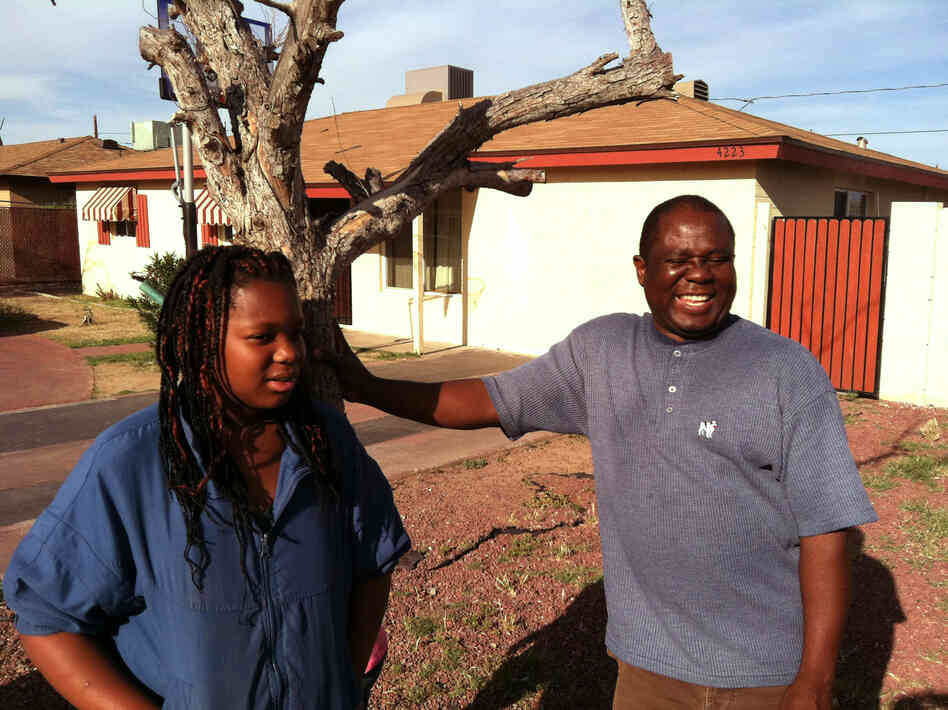 John Larsala struggles to keep his family cool during the Phoenix summer. The shade trees in his front yard have died because he cannot afford to water them.