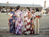 Young women wearing kimonos chat during an Obon celebration honoring ancestors at the Heart Mountain Relocation Center in Wyoming.