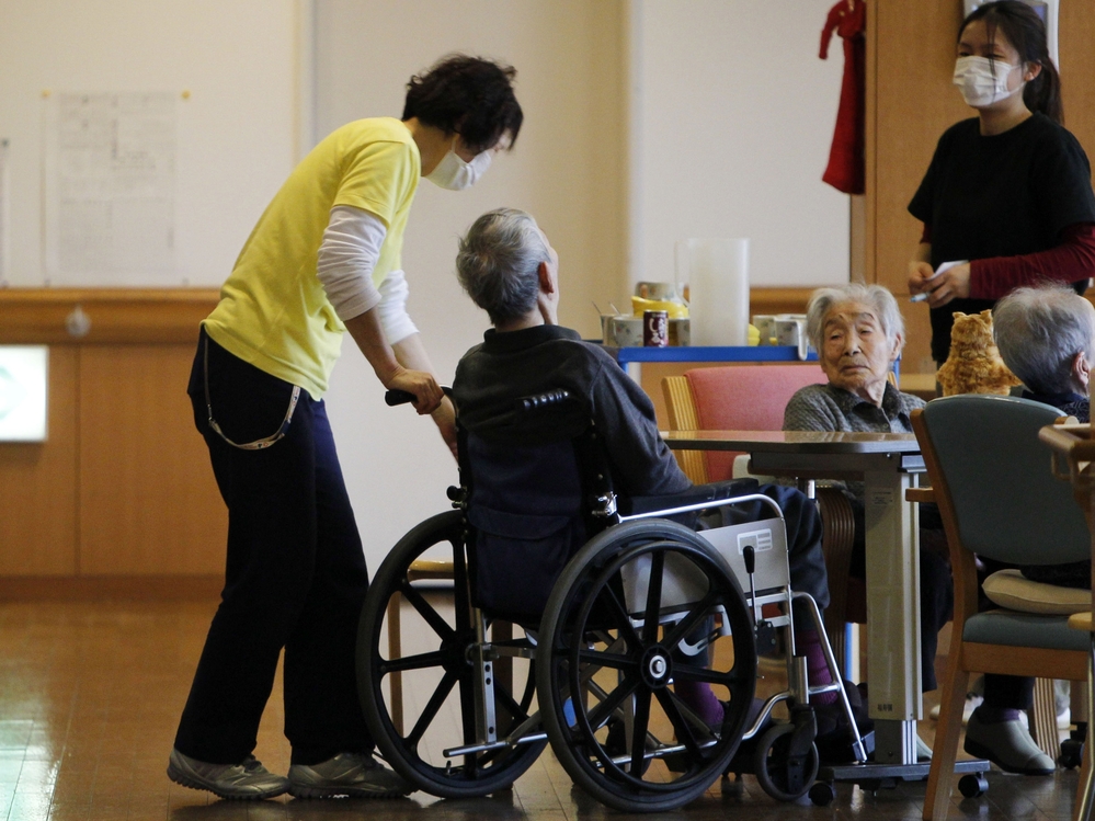 Care managers tend elderly people in March 2012 in Minamisoma, Japan. The home's residents were evacuated eight days after the Fukushima Dai-ichi nuclear power station was crippled by the March 11, 2011 tsunami.